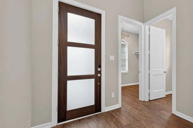 a view of a hallway with wooden floor