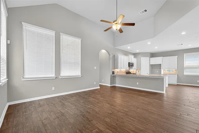 a view of a kitchen with a sink hardwood floor and a window