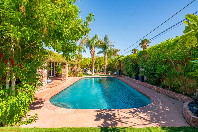 a kitchen with stainless steel appliances granite countertop a stove a refrigerator and a wooden floor