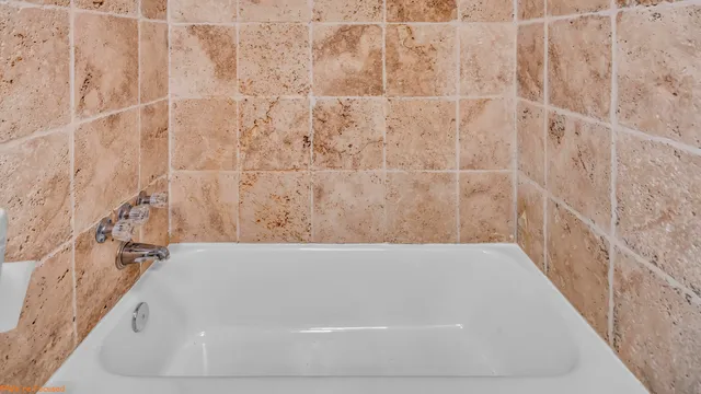 a view of a patio with table and chairs with wooden fence and plants