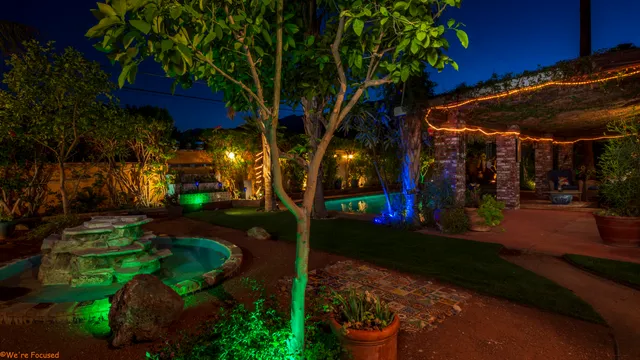 a front view of a house with a yard fountain and outdoor seating
