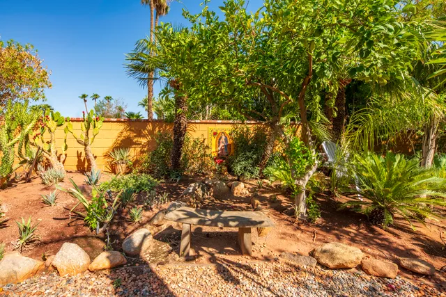 a backyard of a house with lots of green space and garden