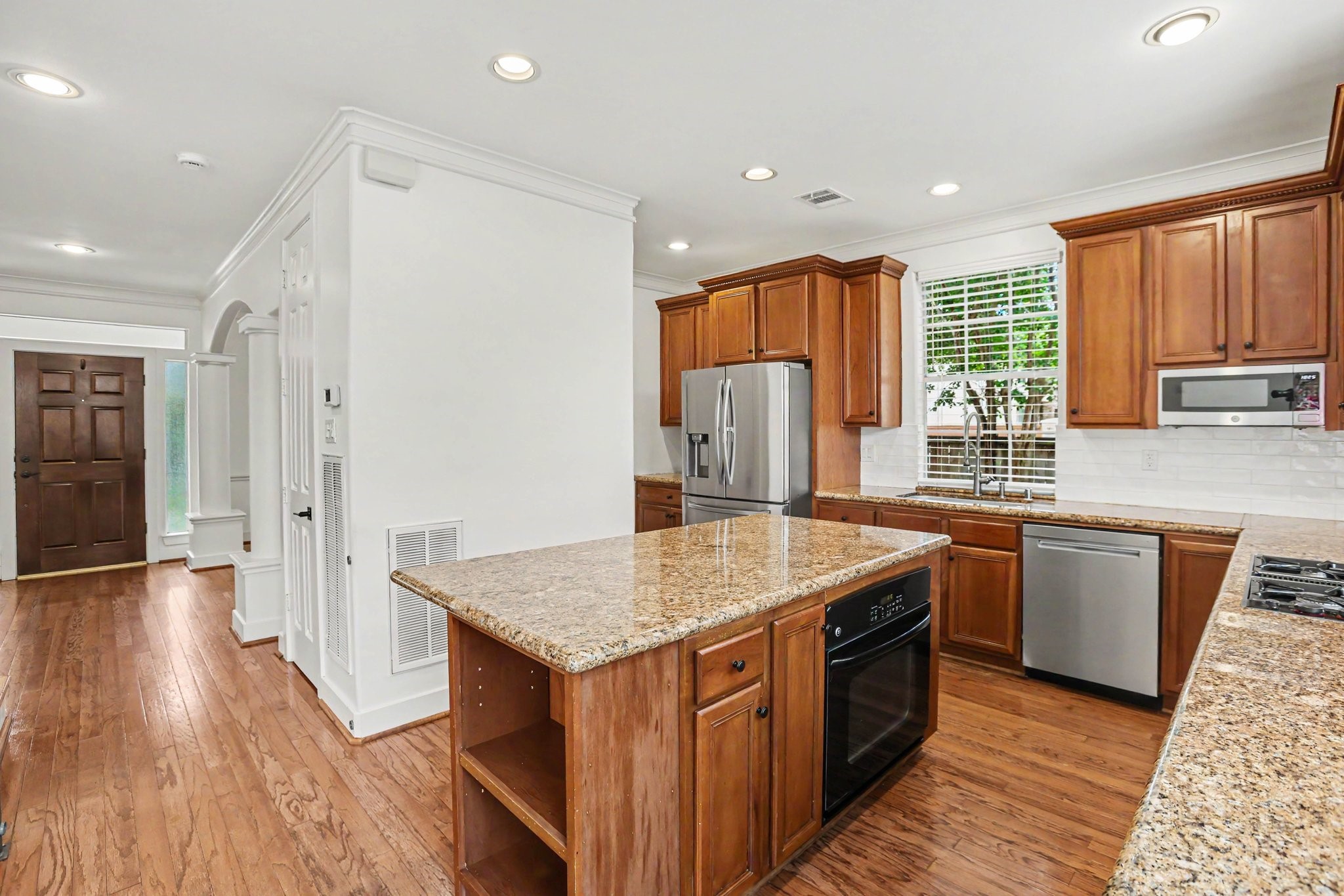 1470 Springrock Lane, Unit 6 Houston, TX 77055 - Photo 10 of 31 This kitchen features warm wood cabinetry, granite countertops, crown molding, and stainless steel appliances. Refrigerator included.