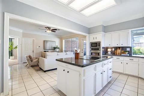 a kitchen with stainless steel appliances granite countertop a sink and cabinets