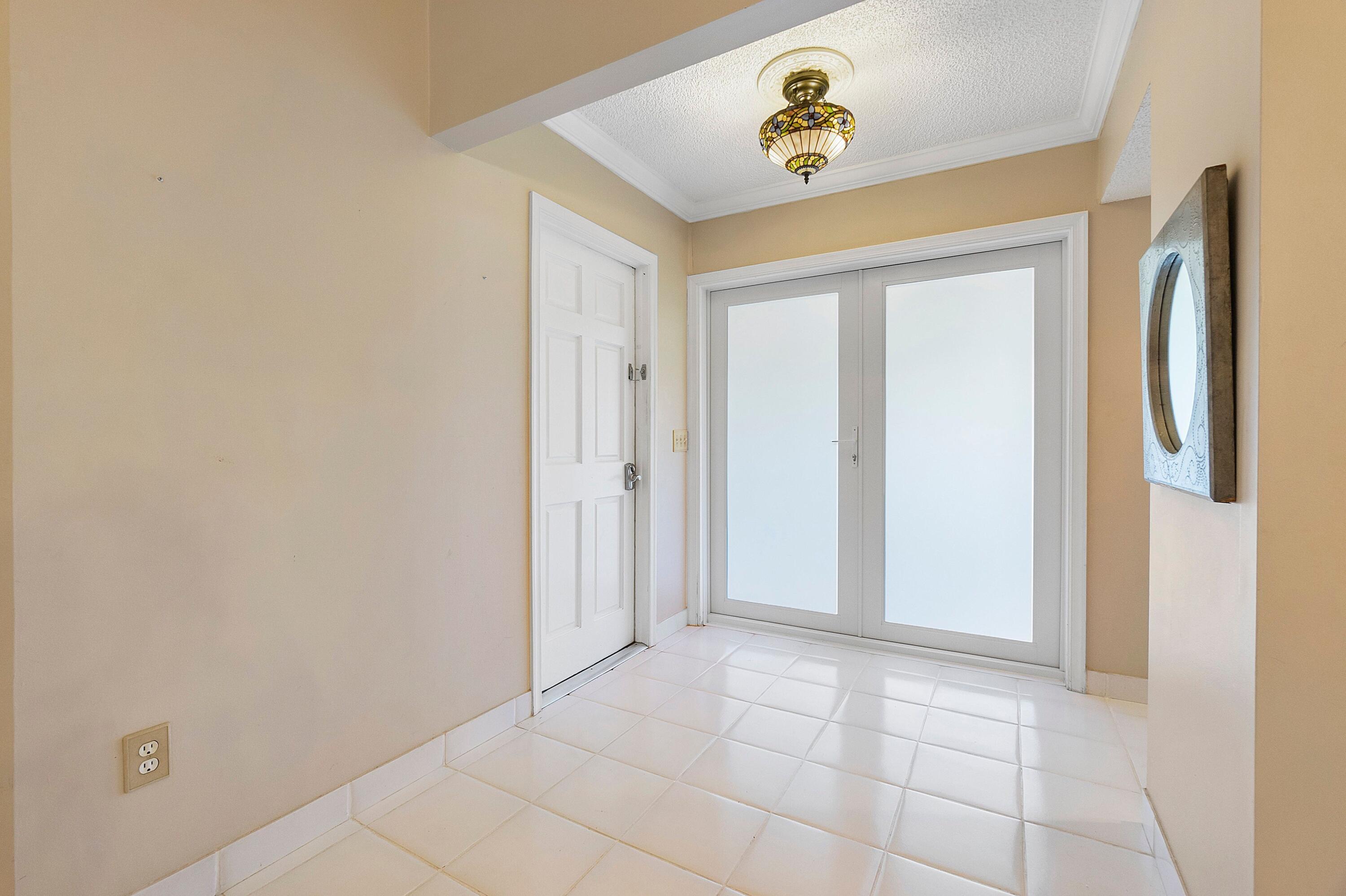 275 Northwest 69th Street Boca Raton, FL 33487 - Photo 12 of 34 boca lake front door area foyer