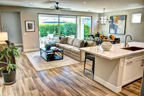a view of a patio with chairs under an umbrella
