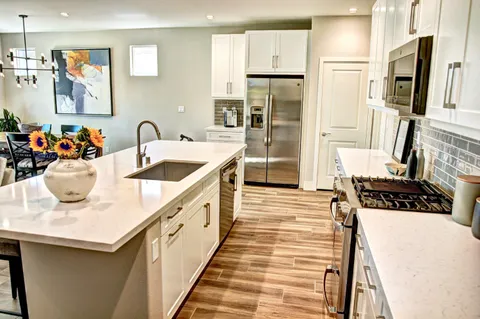 a living room with furniture and painting on the wall