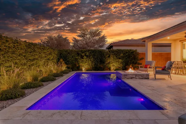 a view of a patio with table and chairs and potted plants