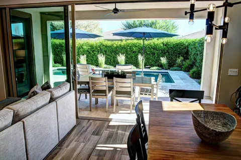 a park with lots of green space and fountain in the back