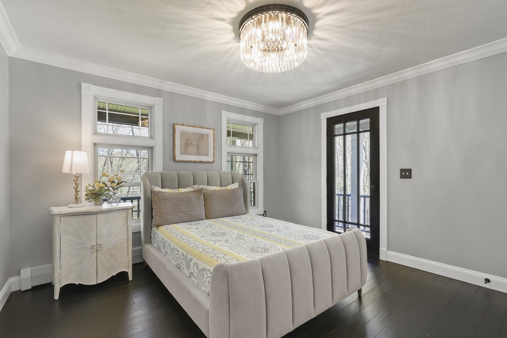 52 Fales Road Plainville, MA 02762 - Photo 25 of 41 a bedroom with a large bed and a chandelier