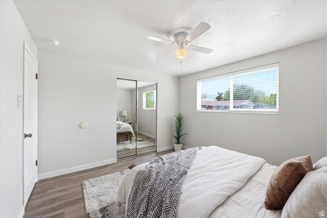 215 Carol Way Midvale, UT 84047 - Photo 16 of 30 Bedroom featuring wood finished floors, a closet, and a ceiling fan