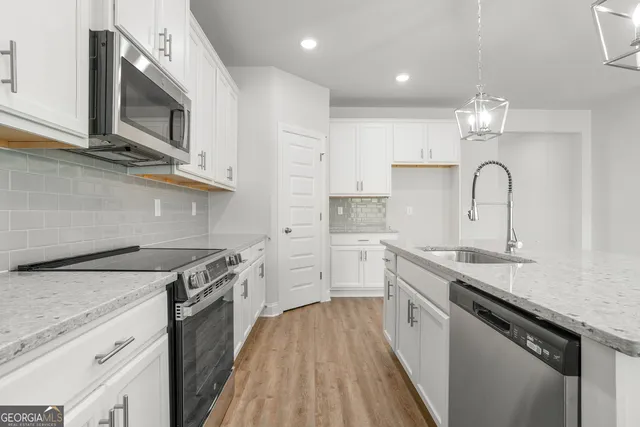 a kitchen with a sink stove top oven and cabinets