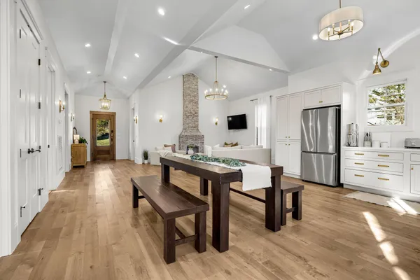 a open kitchen with stainless steel appliances kitchen island granite countertop a refrigerator and microwave