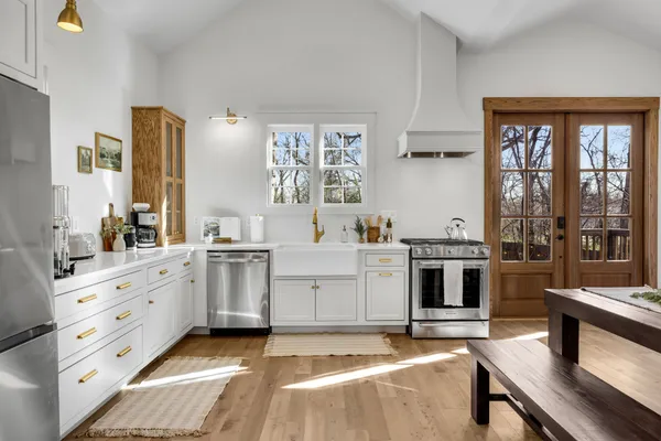 a kitchen with stove and cabinets