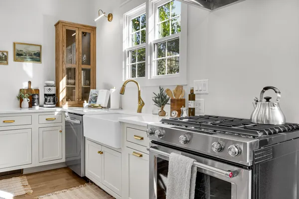 a kitchen with cabinets stainless steel appliances and window