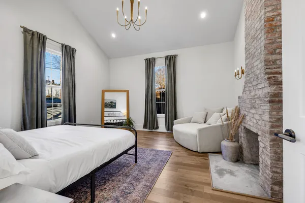 a bedroom with a bed and a large mirror