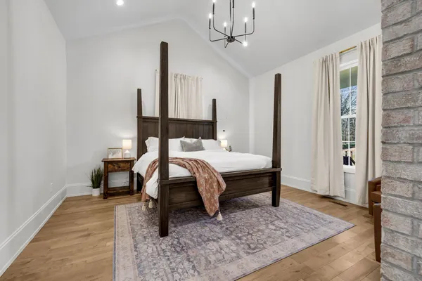 a bedroom with a bed and glass walk in closet