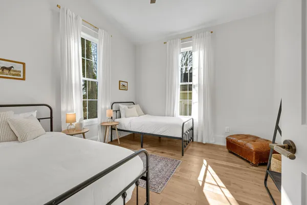 a view of a deck with a floor to ceiling window next to a yard