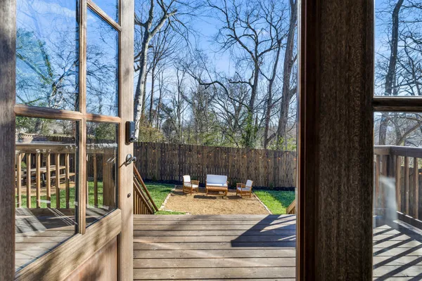 a view of balcony with wooden floor and fence