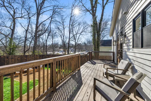 a view of a backyard with wooden fence and a slide