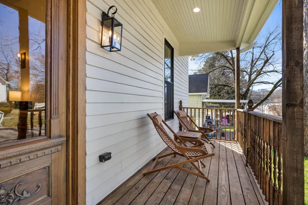 a view of balcony with wooden floor and outdoor seating