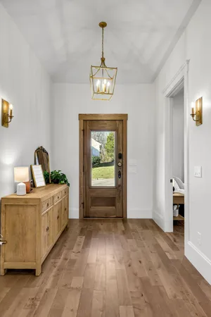 a view of a bedroom with furniture window and wooden floor