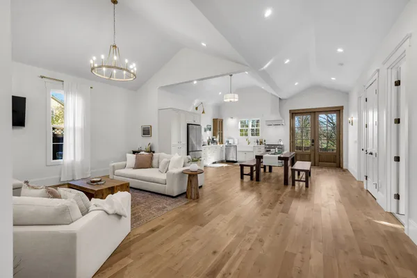 a living room with furniture and wooden floor