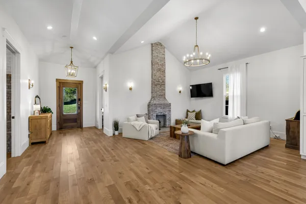 a living room with furniture and a chandelier