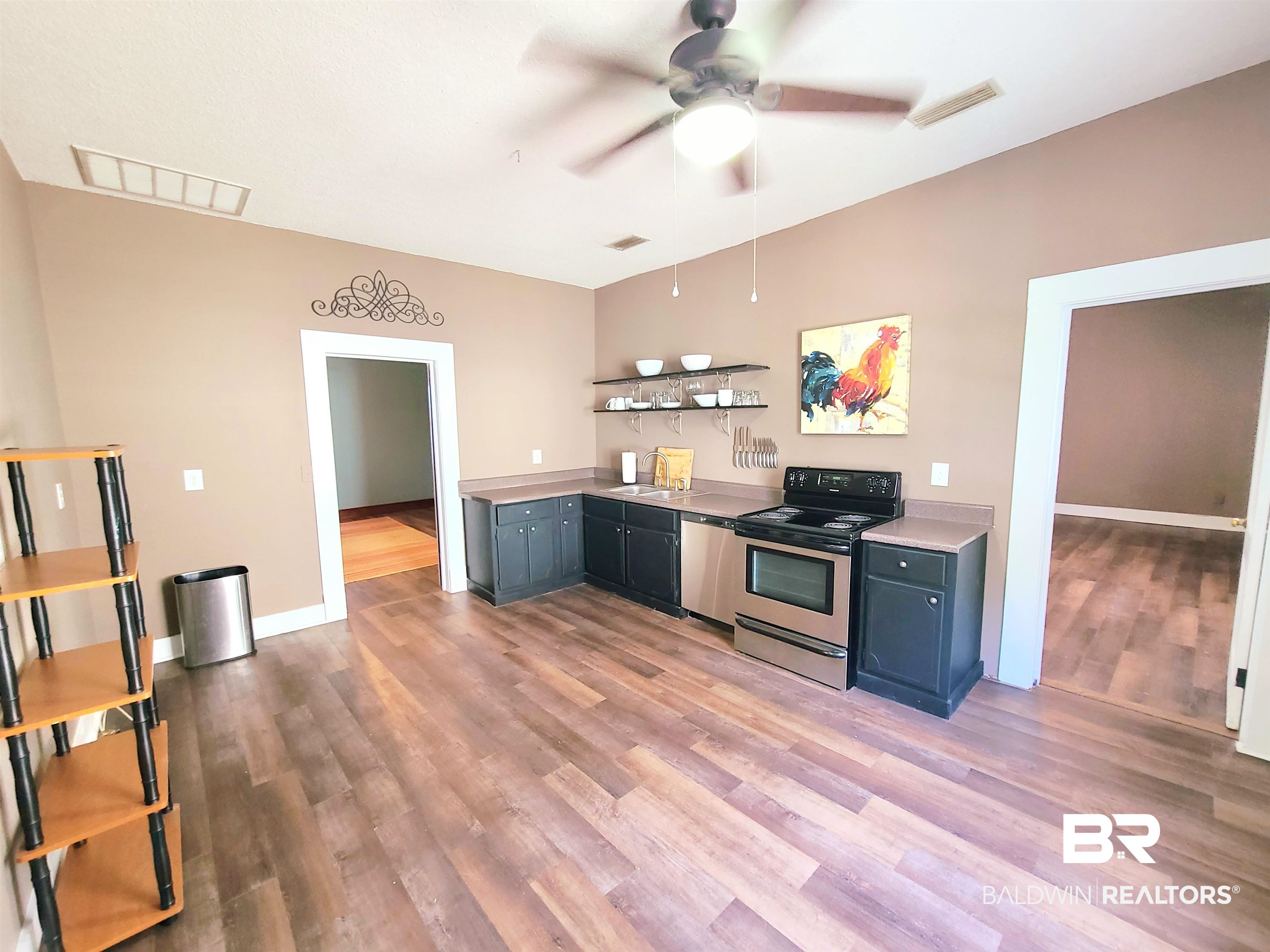 112 Espejo Street Mobile, AL 36604 - Photo 4 of 20 Kitchen featuring visible vents, ceiling fan, light wood-style floors, and appliances with stainless steel finishes