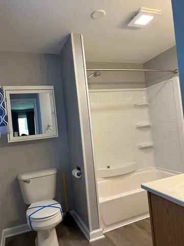 a bathroom with a toilet and a shower