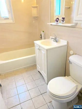 a bathroom with a sink a toilet and bathtub