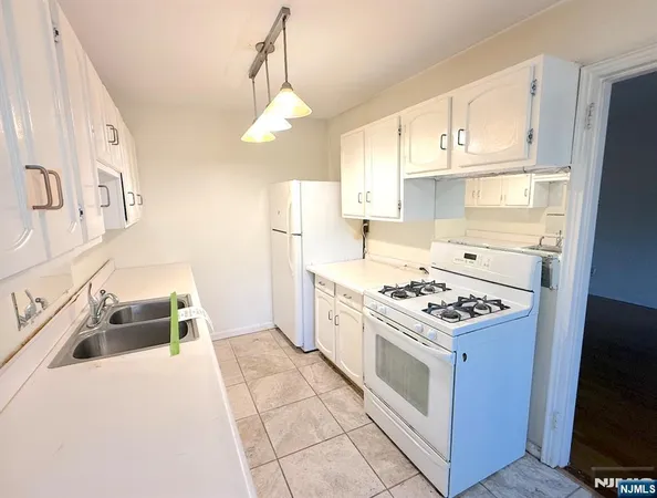 a kitchen with stainless steel appliances granite countertop a stove and a refrigerator