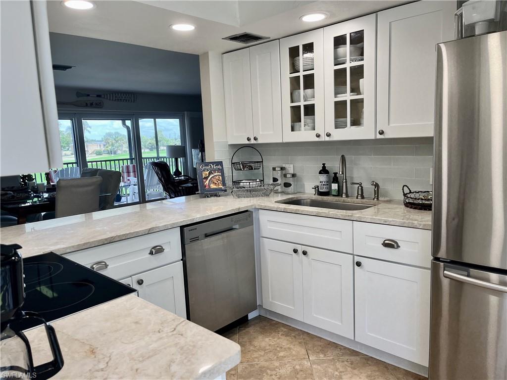 348 Tern Drive, Unit 4 Naples, FL 34112 - Photo 1 of 27 a kitchen with stainless steel appliances a sink stove and cabinets