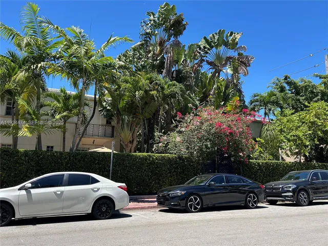 a car parked in front of a white house