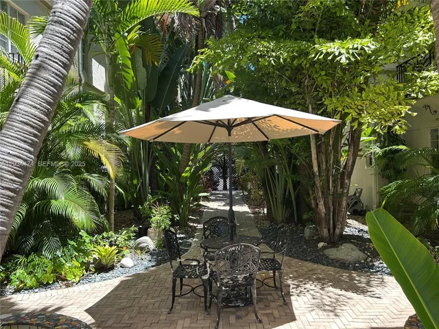 a view of backyard with plants and outdoor seating