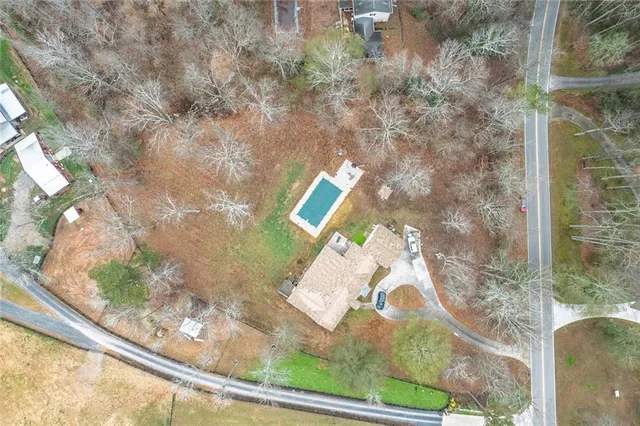 a floor to ceiling window with tree in front of it