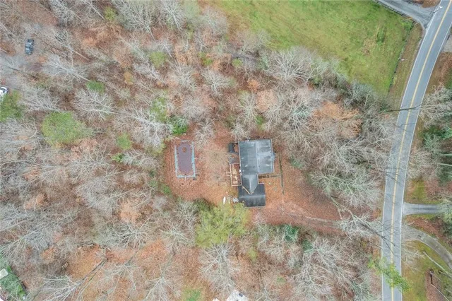 a aerial view of a residential houses with yard