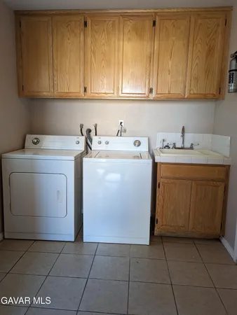 a kitchen with granite countertop a stove a sink and a refrigerator