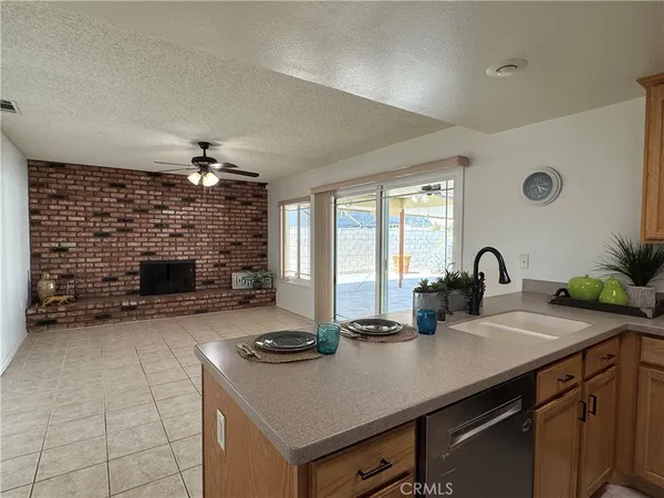 a kitchen with stainless steel appliances a refrigerator a sink a stove a microwave a counter top space and cabinets