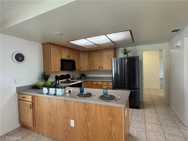 a kitchen with stainless steel appliances granite countertop a sink a stove and refrigerator