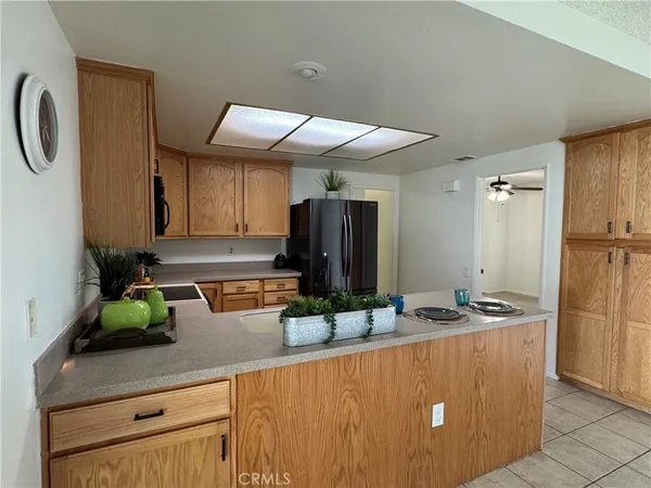 a kitchen with stainless steel appliances granite countertop a sink refrigerator and microwave