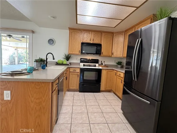 an empty room with fireplace and fan