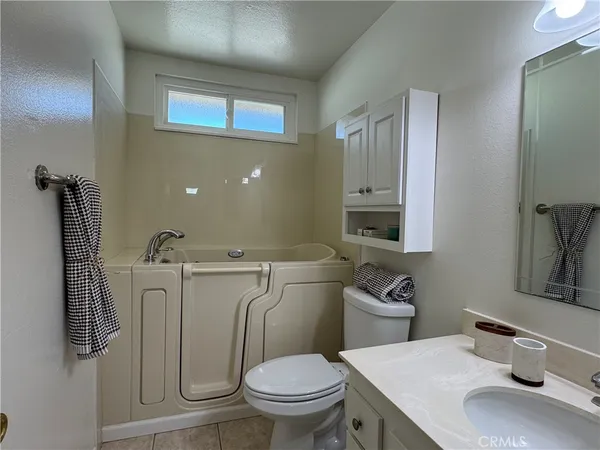 a bathroom with a sink toilet and a mirror