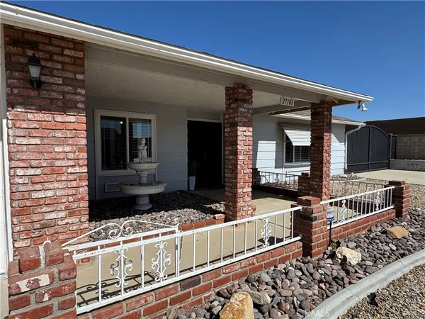 a view of a balcony with two couches and wooden floor