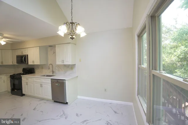 a view of a kitchen with a sink and dishwasher kitchen view