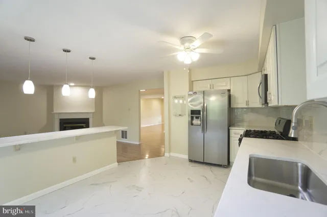 a kitchen with stainless steel appliances a refrigerator sink and stove