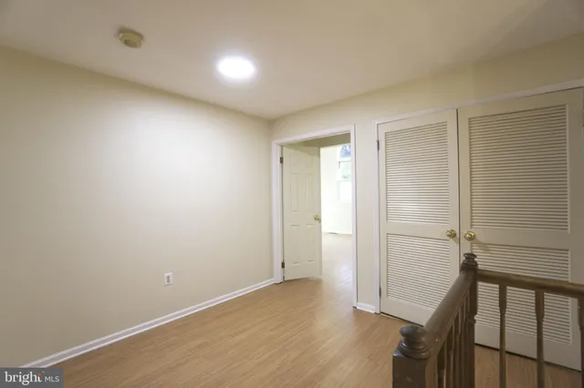 a view of hallway with wooden floor