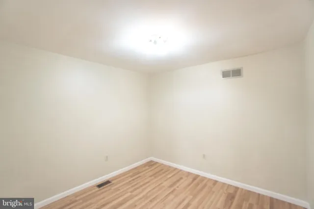 a view of a room with wooden floor and brick walls
