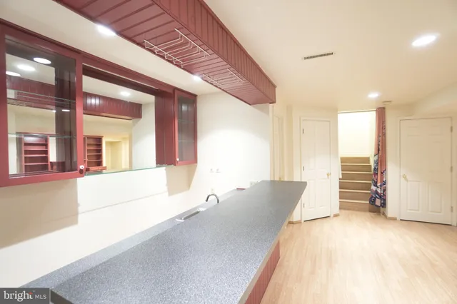 a view of bathroom with a sink mirror and toilet
