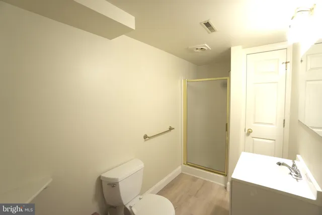 a bathroom with a shower and a sink